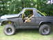 1986 Ford Bronco - This modified SUV features a snorkel, roll cage, and large off-road tires, suggesting it's built for terrain.