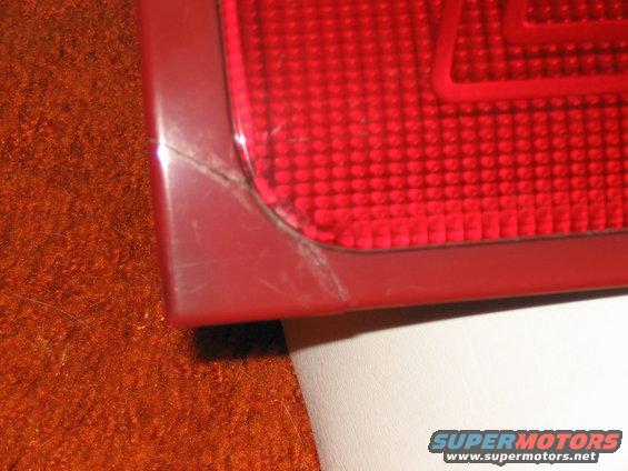 Close-up of a cracked red taillight, possibly from a car