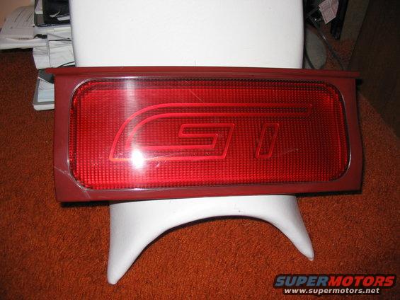 Red taillight assembly with GT emblem, mounted on a white stand