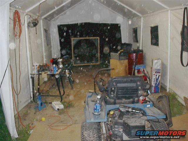 Lawn mower interior in a tent with tools and supplies