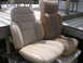 1984 Ford Bronco - Two car seats, likely from an older vehicle, are placed on a wooden deck outdoors.