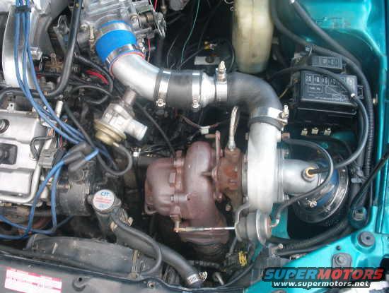 Engine bay with turbocharger and custom intake piping