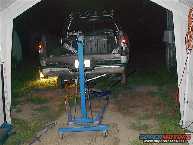 1997 Dodge 1500 pickup truck, rear view, dark color, under a tent, with engine hoist