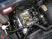 1979 Chevrolet C/K Pickup - Close-up of a V8 engine bay, showing the carburetor and ignition system.