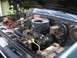 1979 Chevrolet C/K Pickup - The engine bay of a blue 1979 Chevrolet C/K Pickup is shown, revealing the air cleaner and battery.