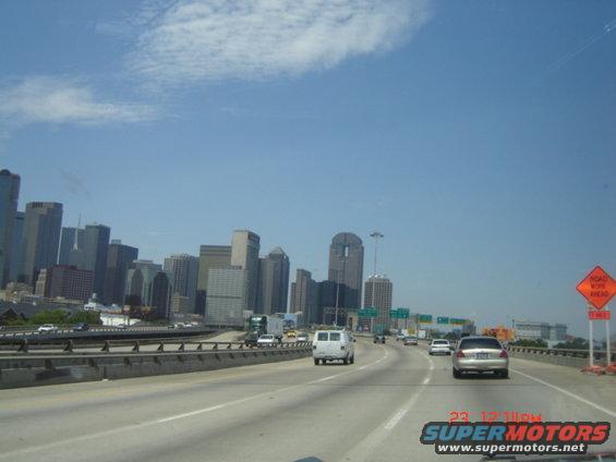 Highway traffic with Dallas skyline in the background