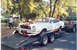 1978 Ford Mustang II - 1978 Ford Mustang II Cobra being transported on a trailer with a pickup truck in the background.