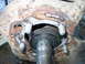 1995 Ford Bronco - Rusted wheel hub assembly showing bearing and shaft, likely needing replacement.