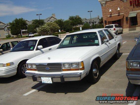 1988 Ford Crown Victoria parked in a lot next to another car
