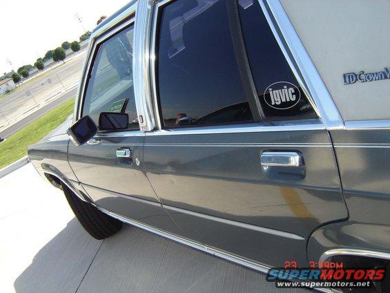 Side view of a 1988 Ford Crown Victoria LTD with a sticker on the rear window