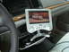 1996 Ford Crown Victoria - A portable screen displays a white vehicle, mounted on the dashboard of another car.