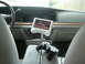1996 Ford Crown Victoria - The interior of a car features a video screen and a game controller on the center console.