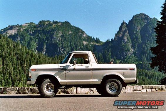 Side view of a white 1979 Ford Bronco parked on a scenic overlook