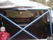 1978 Ford Bronco - The interior of a vehicle is visible, a blue roll cage and black seats, with a red gas can in the foreground.