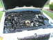 2000 Mercury Grand Marquis - The engine bay of a car is open, revealing the motor and its components.