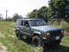 2000 Jeep Cherokee - This 2000 Jeep Cherokee is seen parked off-road on a sunny day.