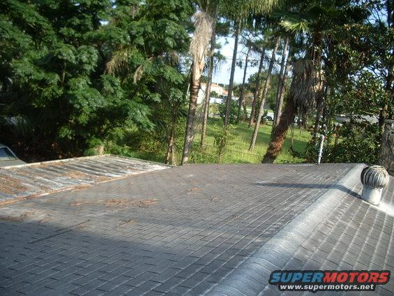 Roof with vent and trees in background