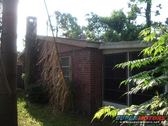 House exterior with brick walls and a screened porch