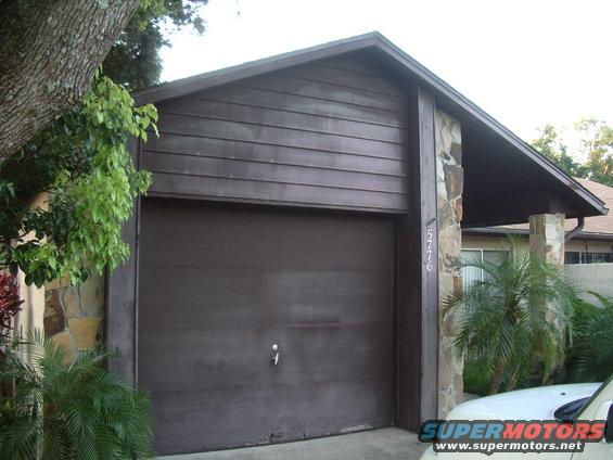 House with brown garage door and stone accents, address 5776 visible