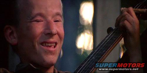 Young boy playing a stringed instrument, Supermotors.net logo visible