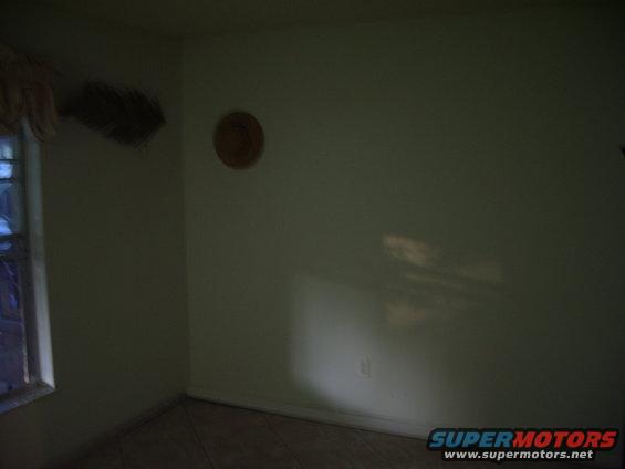 Interior room with a window on the left and a circular decoration on the wall