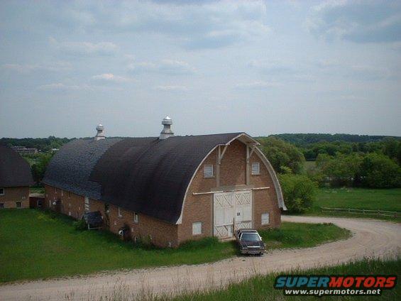 In front of one of the barns of the Traverse City State Hospital.  The barns were built just prior to the Depression.