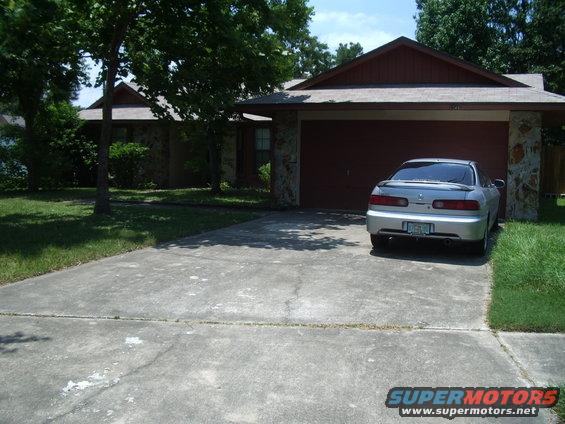 Silver sedan parked in front of a garage