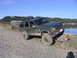 2000 Jeep Cherokee - Jeep Cherokee navigating a rough, muddy path near the water's edge.