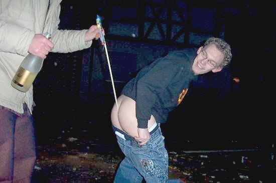 Person with exposed buttocks and a firework being lit