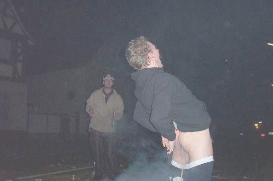 guy looking up at night, another guy behind him