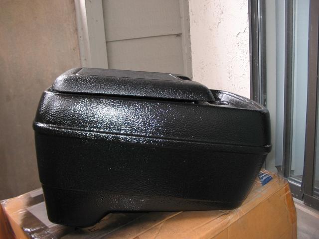 Black textured plastic center console armrest, side view