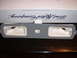 1978 Ford Mustang II - A Ford Motor Company branded box contains a license plate light assembly with two clear lenses.