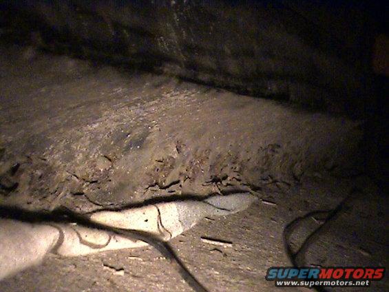 Underside of vehicle showing rust and debris