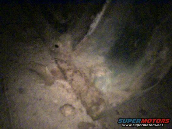 Close-up of heavily rusted metal, possibly from a car's undercarriage