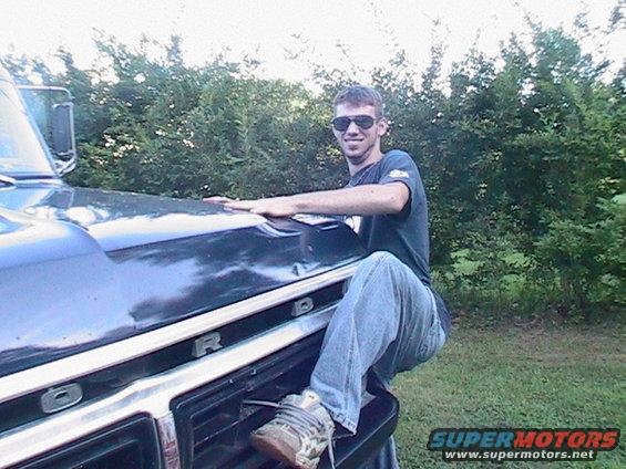 1977 Ford F-250 grille with man posing on it