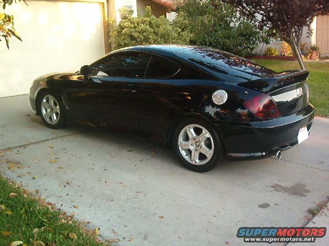 Black 2003 Hyundai Tiburon parked in a driveway
