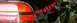 1990 Mitsubishi Eclipse - The rear section of a black car is visible, a red tail light and text on its side.