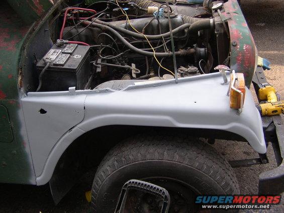 1973 Jeep CJ5 fender and engine bay with battery and wiring visible