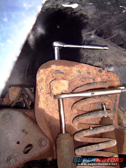 Taking off the top bolt of the shock is really easy with a ratchet and a pair of vise grips.  