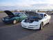 1993 Ford Probe - A white 1993 Ford Probe is parked next to a teal sedan, both with hoods open.