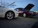1993 Ford Probe - Two cars parked with their hoods open, possibly at a track event.