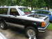 1989 Ford Bronco II - This 1989 Ford Bronco II is shown with its hood open, parked next to another vehicle.