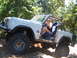 1988 Ford Bronco - This modified SUV, likely a Ford Bronco from the late 1970s, navigates a rocky trail.