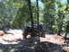 1988 Ford Bronco - Off-road Jeep CJ-7 tackles a challenging dirt path through a forest.