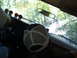 1988 Ford Bronco - View from inside a 1988 Ford Bronco, showing aftermarket gauges and a scene outside with another vehicle and a person.