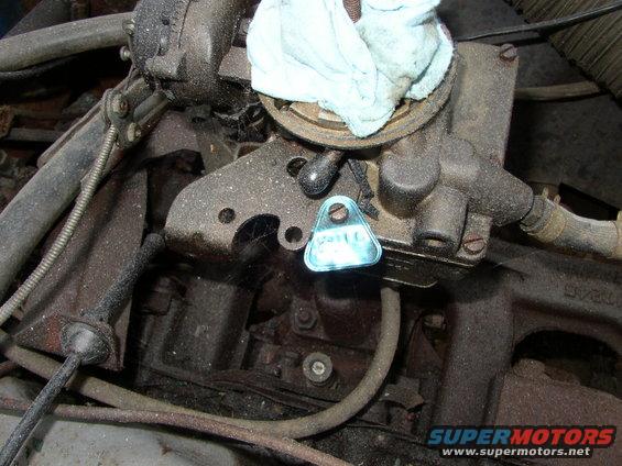 Close-up of engine component with a blue triangular tag attached