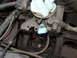 1973 Jeep CJ5 - Engine part with a blue tag, possibly an oil cap or identification marker.