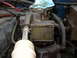 1973 Jeep CJ5 - Engine bay detail shows a carburetor with visible grime and surrounding mechanical components.