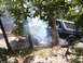 1988 Ford Bronco - A 1988 Ford Bronco kicks up dust and smoke while navigating a wooded trail.