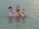 1989 Ford Bronco - A man and three children are in the water at a beach.